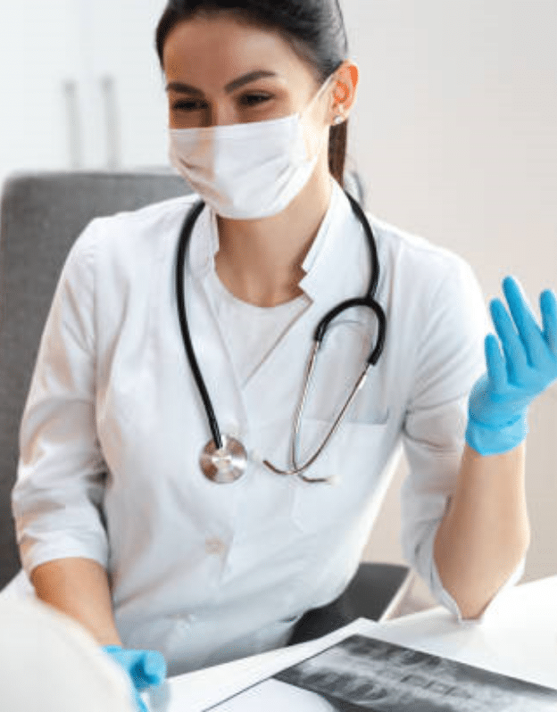 Smiling young nurse wearing blue latex gloves