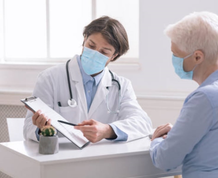 Young male doctor talking to a patient