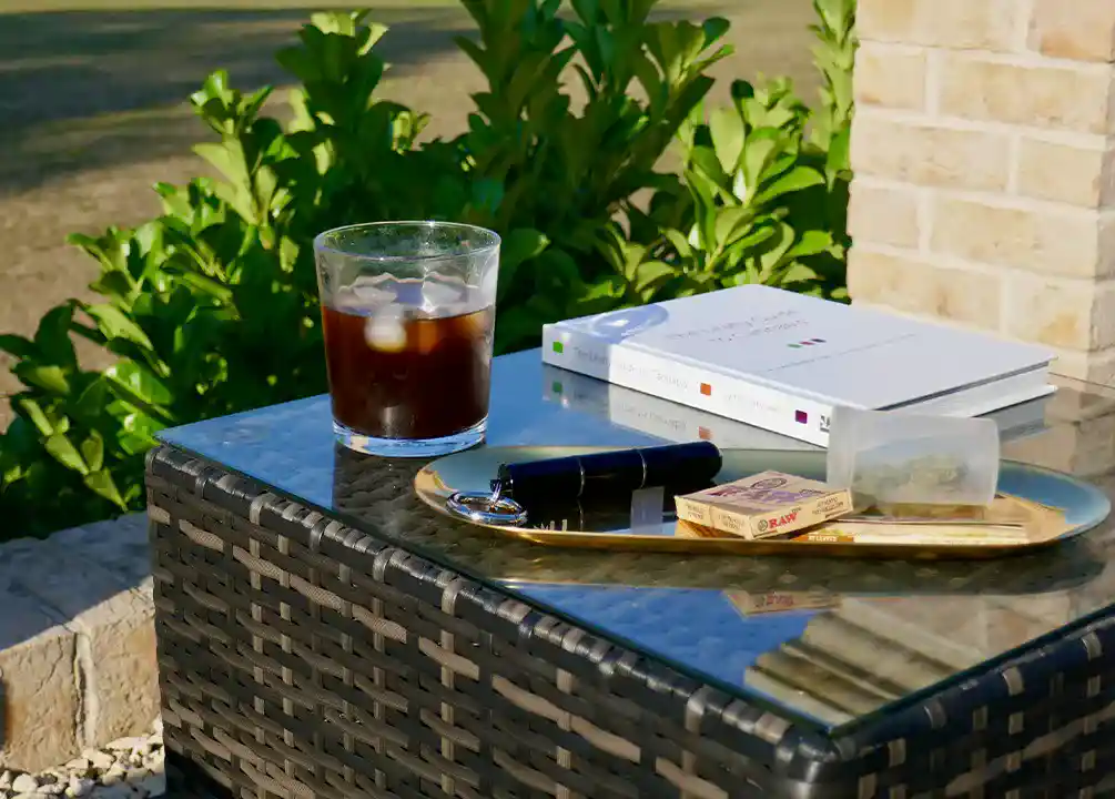 Cannabis products next to a glass of ice coffee