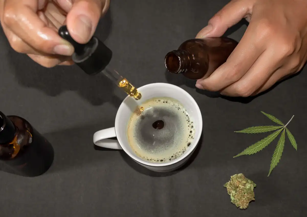 adding cannabis oil to a cup of black coffee