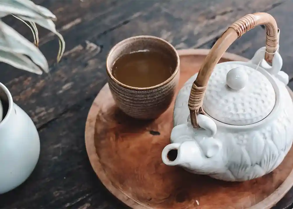 Tea pot and cup with cannabis infused tea