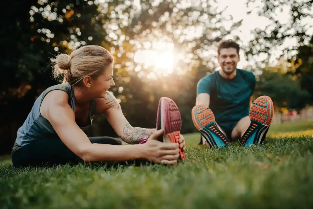 Young couple stretching after exercising