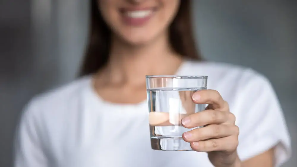 Woman holding a glass of water