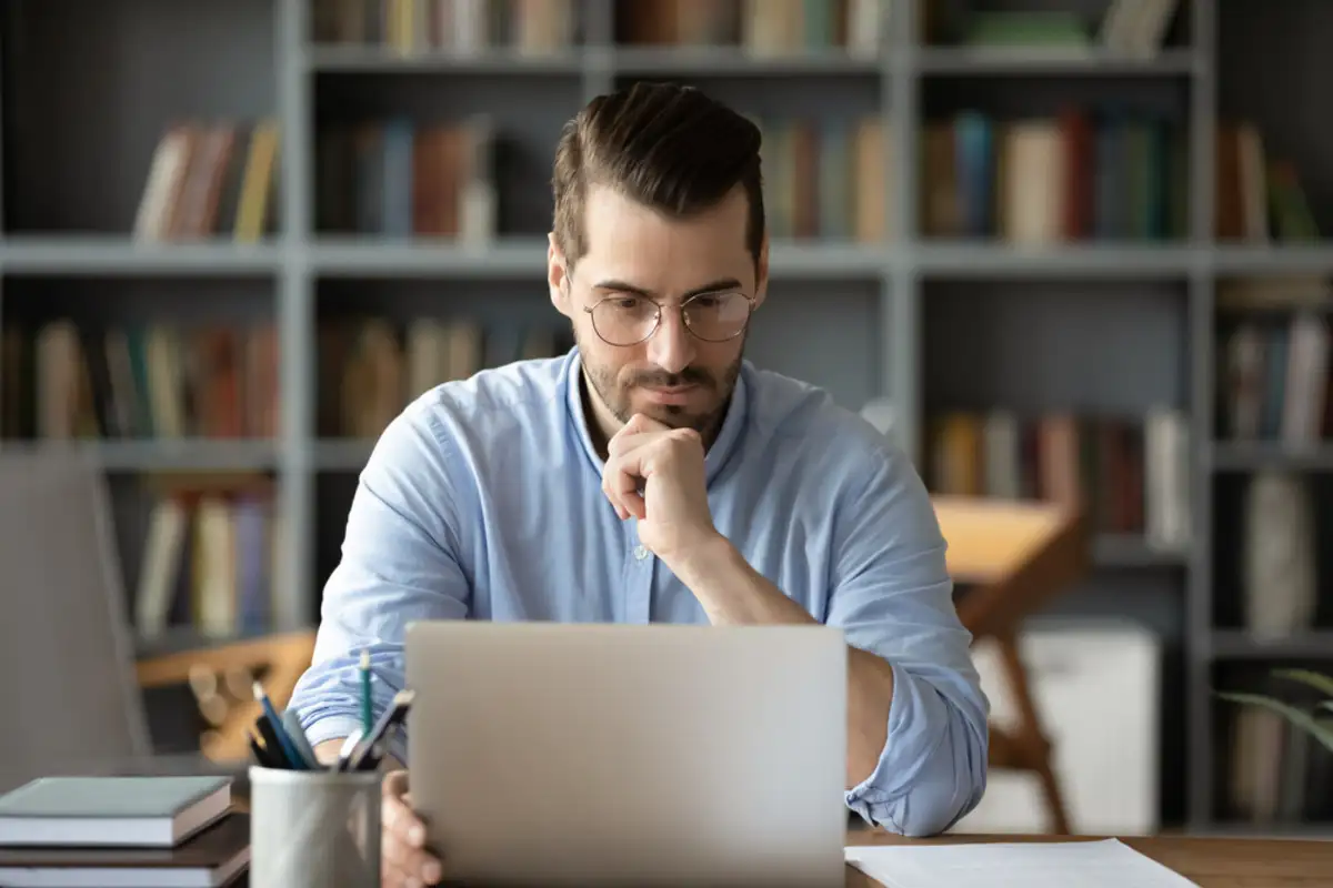 man sitting in front of a laptop computer