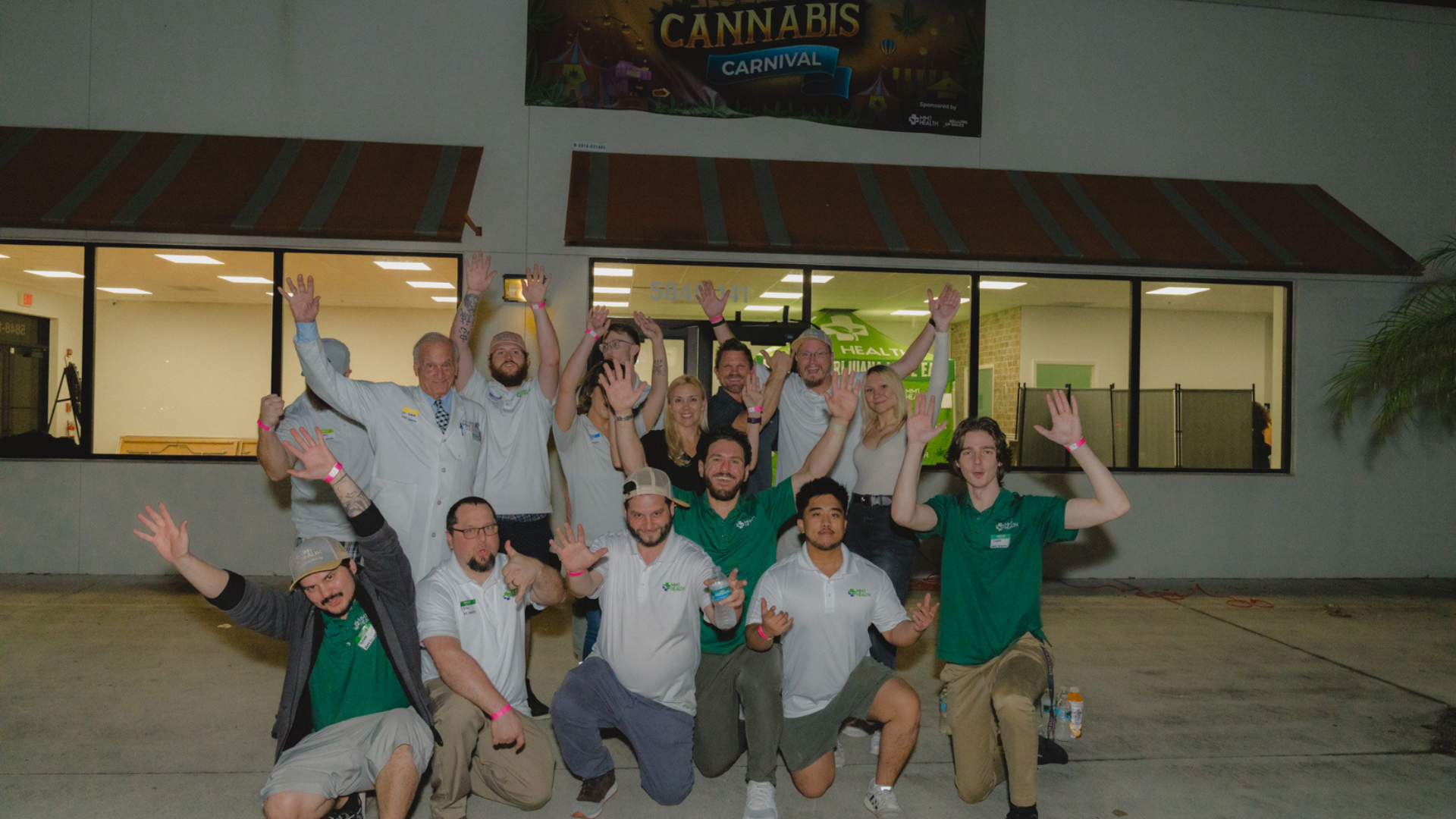 MMJ Health team celebrating with dispensary workers at the Cannabis Carnival in Florida.